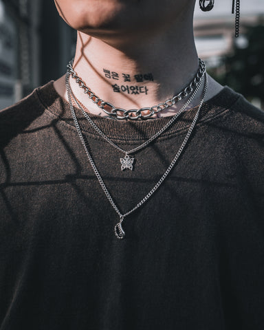 tattooed model with layered punk rock necklaces