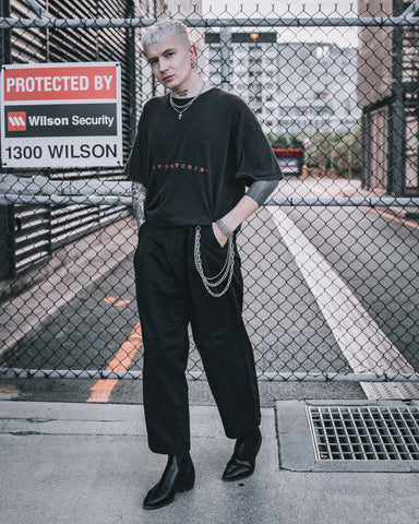 Model wearing punk rock jewellery in urban location