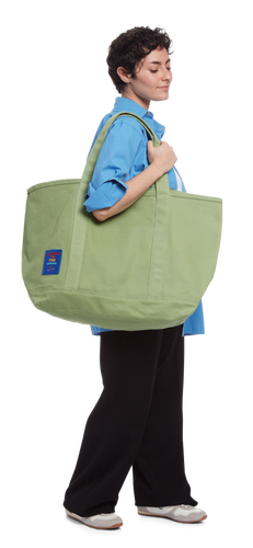 model sporting the Canvas Tote in the color Mineral Green