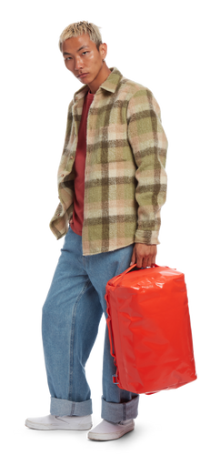 model sporting the Go-Bag — Mini in the color Mandarin Red