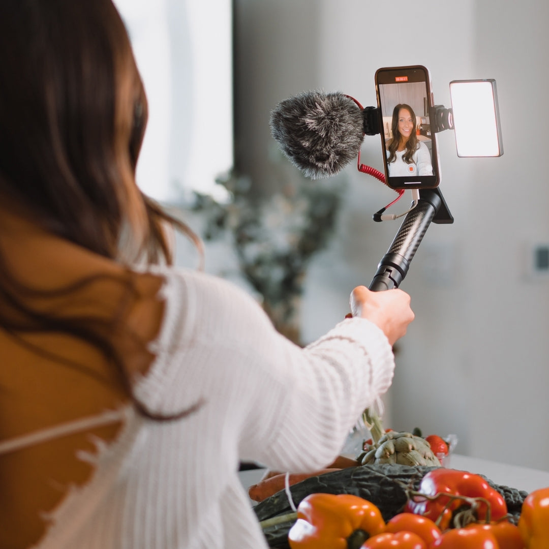girl vlogging in kitchen on iphone using mobile creator kit from lume cube