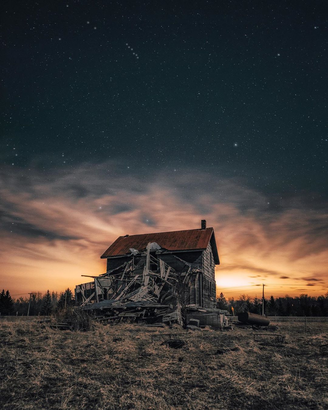 abandoned house with cloudy storm sky above