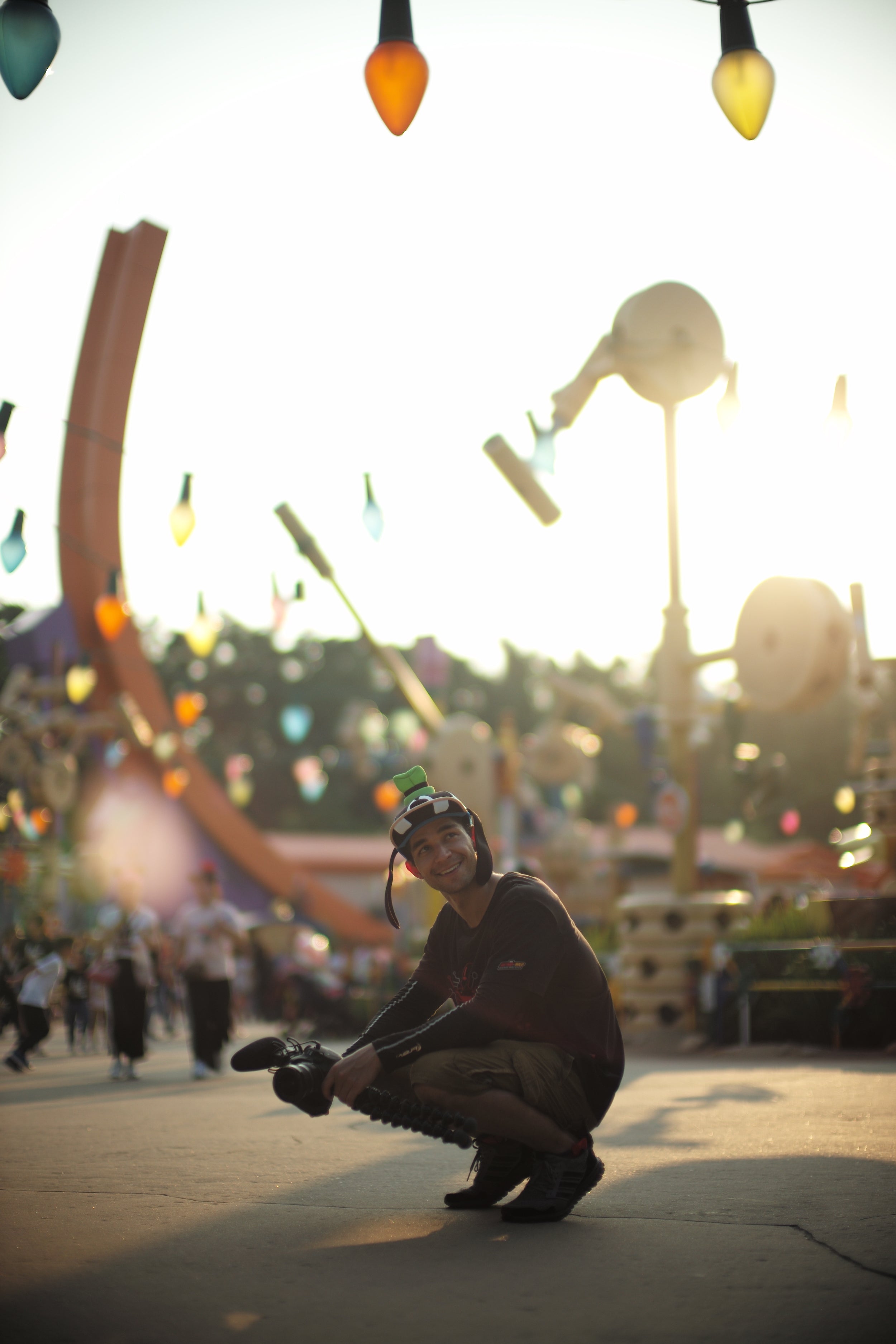 wil at amusement park surrounded by colorful lights