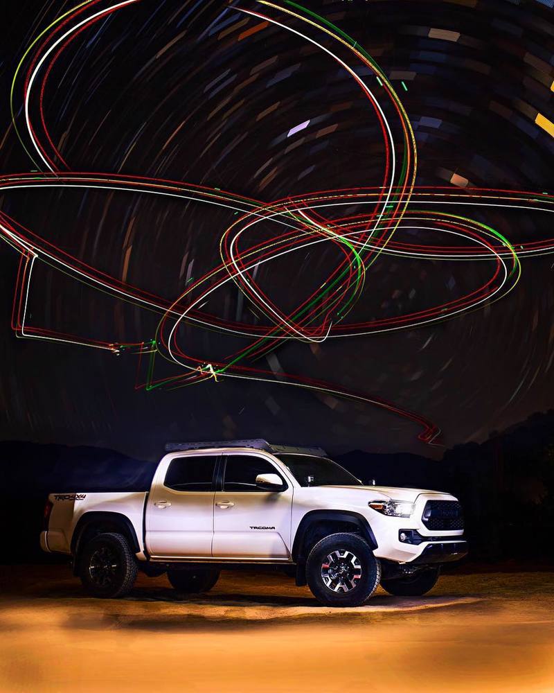 silver truck with drone LED light painting above