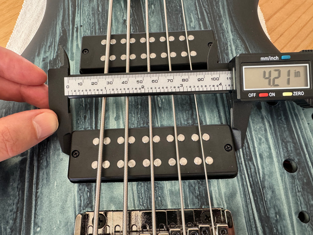 Photograph showing measuring a bass pickup with a micrometer