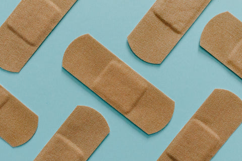 band aids on blue background wound care