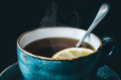 cup of hot tea with lemon spice and spoon