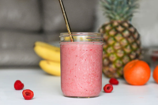 fruit smoothie in mason jar with metal straw pineapple banana raspberry orange