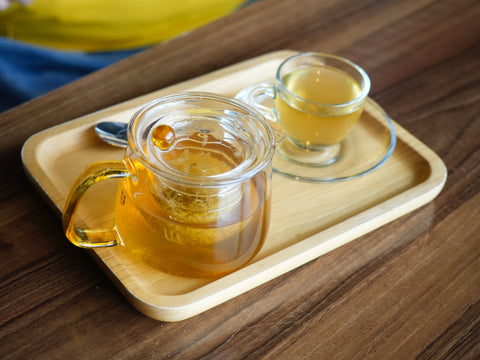 glass of tea with honey on side