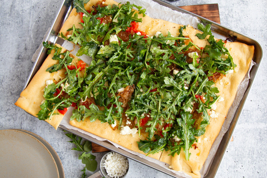 goat cheese peppers onions arugula flatbread pizza with taylor pass manuka honey drizzle