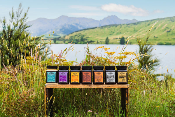 line of taylor pass honey jars on wood bench