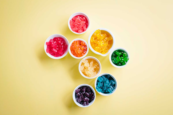 bees and trees rainbow colored gummy bears in bowls