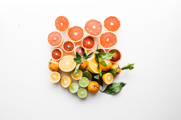 sliced bright citrus fruits on white background