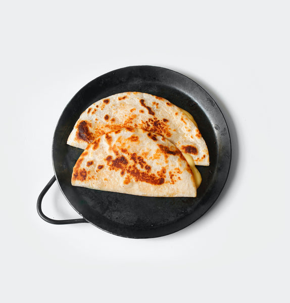 two cheese quesadillas on black plate