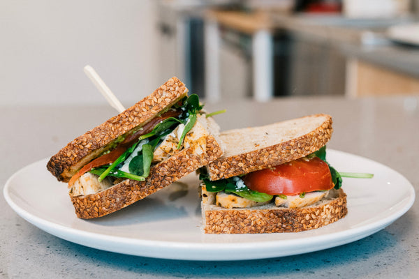 two chicken lettuce tomato sandwiches on plate