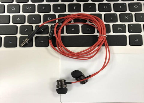 wired stereo earphone on laptop