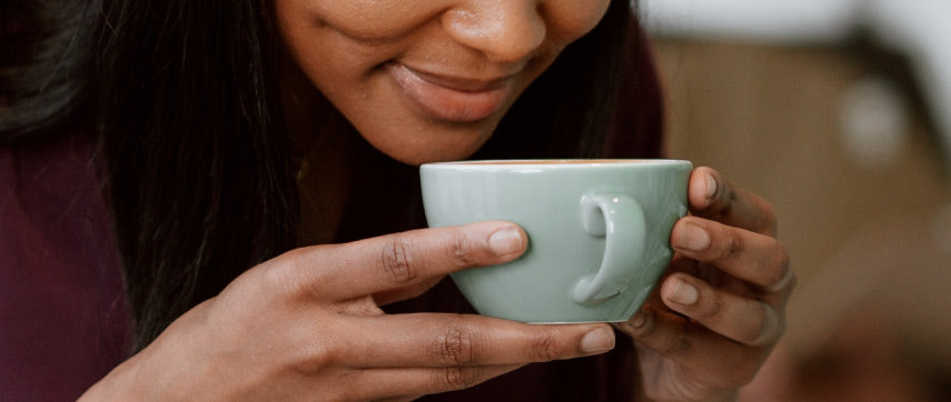 woman smelling coffee