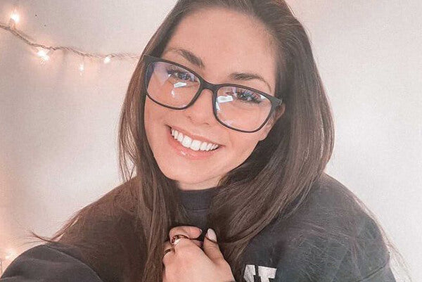 A smiling woman wearing glasses
