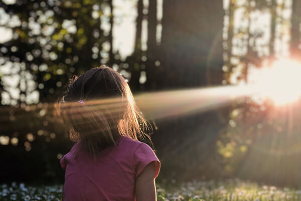 A cute child is following the sun.
