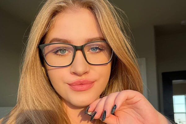 A woman takes a selfie with glasses.