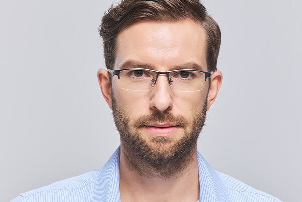 A man wearing rectangular frame glasses