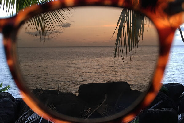 Sunglasses inverted shot at sunset and sea