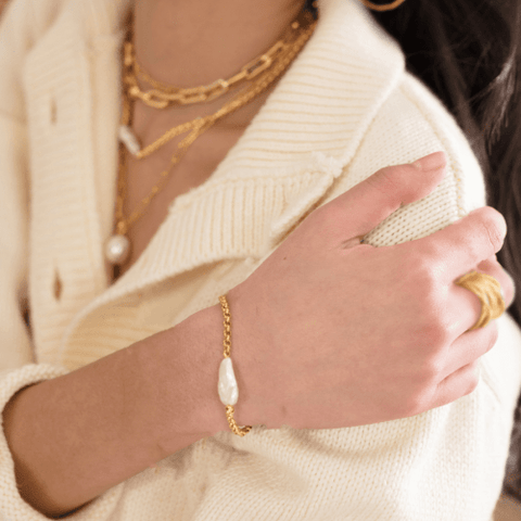 Woman in white sweater wearing Gold Plated Statement Pearl Chain Bracelet
