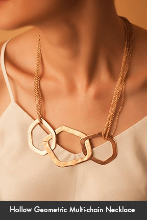 Model wearing hollow asymmetric pendant multi-chain necklace