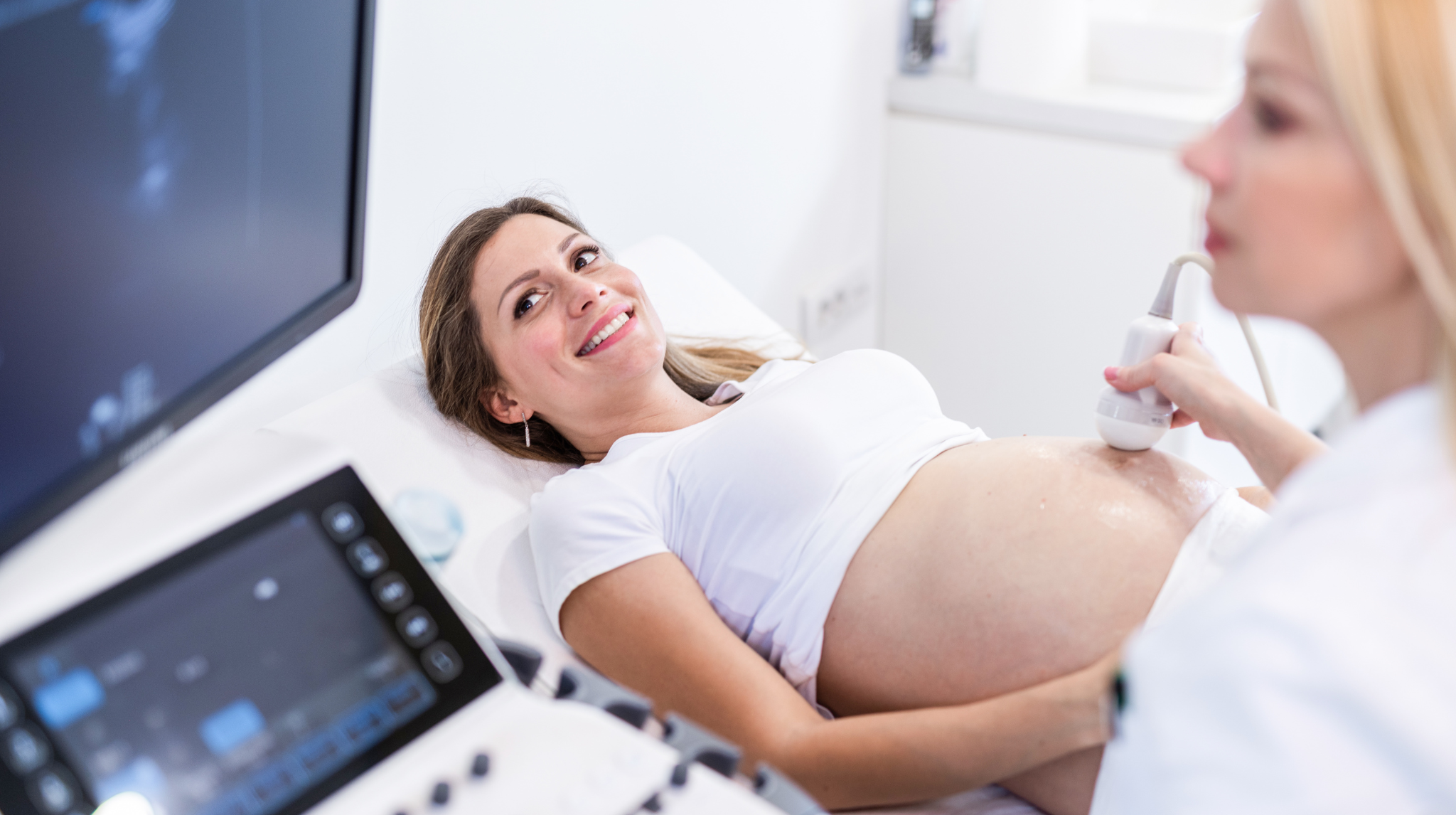 Happy pregnant woman on ultrasound pregnancy examination | Neeva Baby