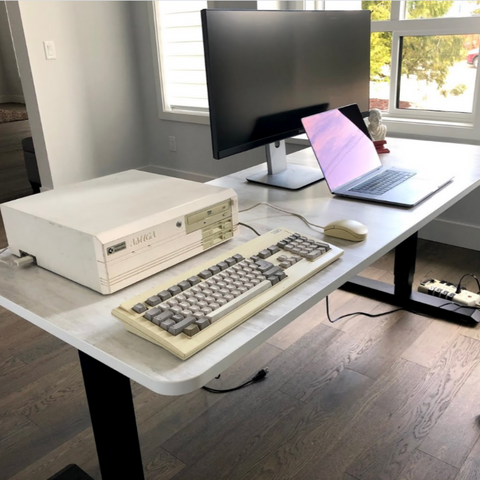 a business office with larger standing desk lets have laptop and monitors