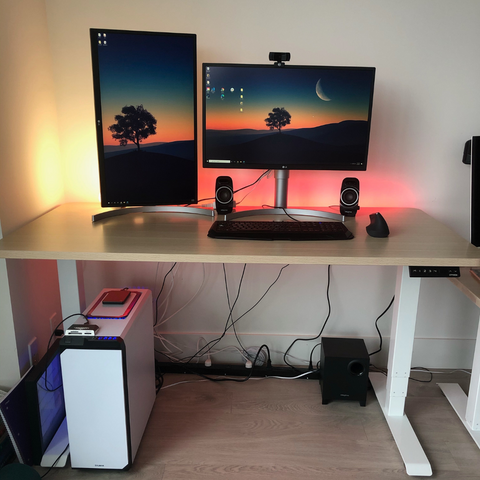 A standing desk with two monitors