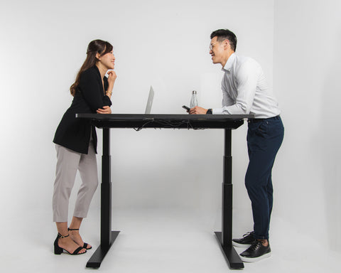 two employees talking and around the business Office Electric Sit-Stand Desk