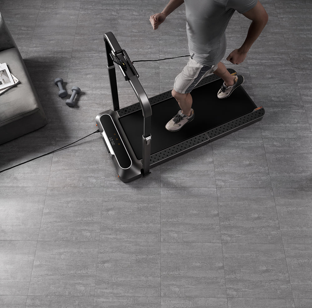 Man running on treadmill desk in his home office