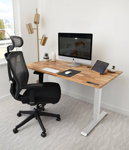 A home office with eco friendly standing desk with Ergonomic chair