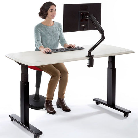 sitting on wobble stool with standing desk