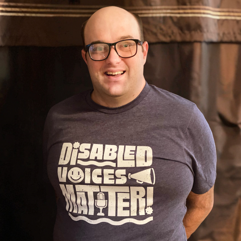 Daniel Smrokowski from Special Chronicles wearing his design called Disabled Voices Matter which can be purchased on Outshine Labels