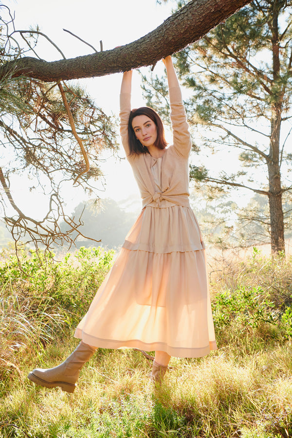 Erin wears the Willow Cardigan over the Lantern Dress in Caramel.