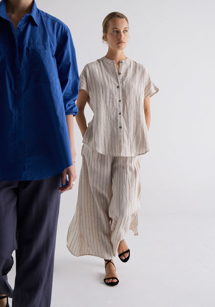 Megumi wears the Louie Pocket Shirt in Marine with the Riley Pant in Indigo, and Esti wears the Filter Linen Stripe Shirt and Pant.