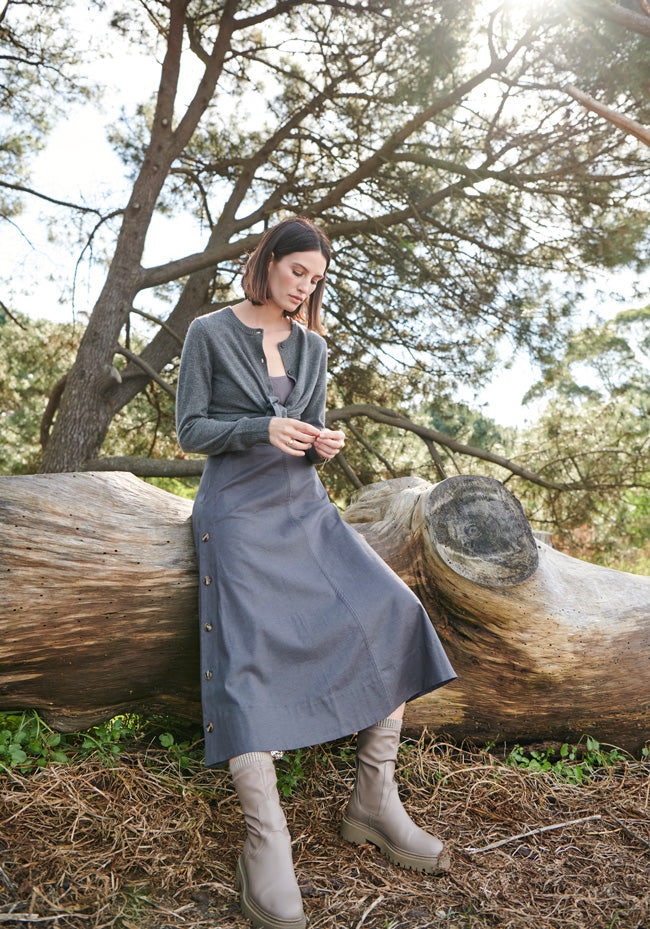 Erin wears the Willow Cardigan over the Illusion Skirt, both in Ash.