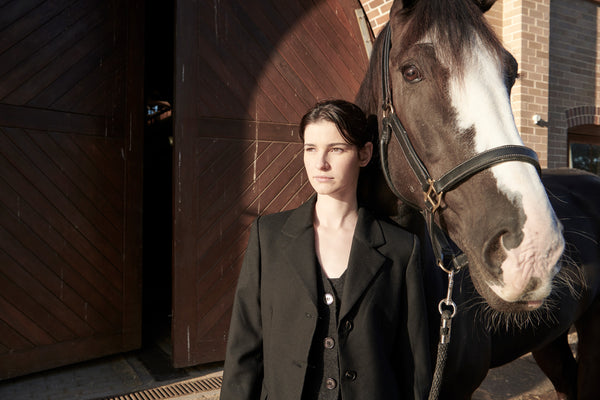 Madi wears the Dressage Jacket in Black with the Tulle Skirt in Black.