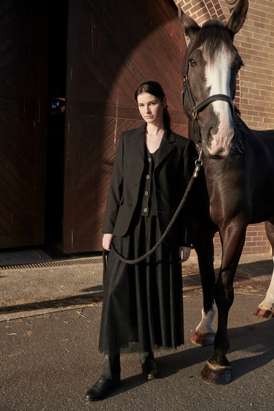 Madi wears the Dressage Jacket in Black with the Tulle Skirt in Black.