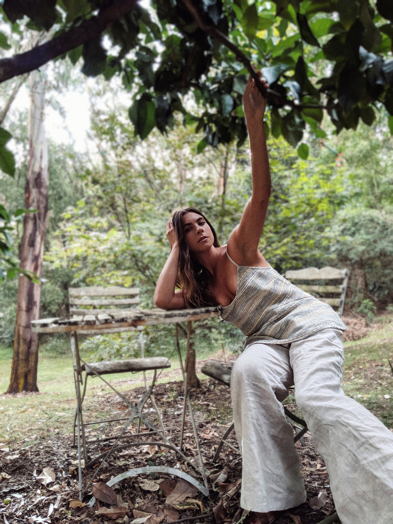 Christelle wears the Nomad Handloom Cami and the Mohave Pants.