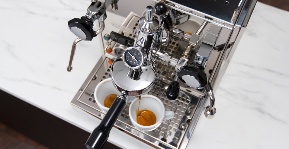 Flow control machine pouring shots of espresso.