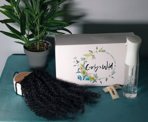 curly and wild box, with hair extensions, spray water bottle and hair accessories