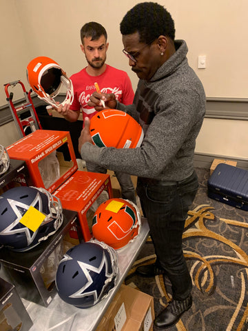 Michael Irvin signing University of Miami Amp helmets