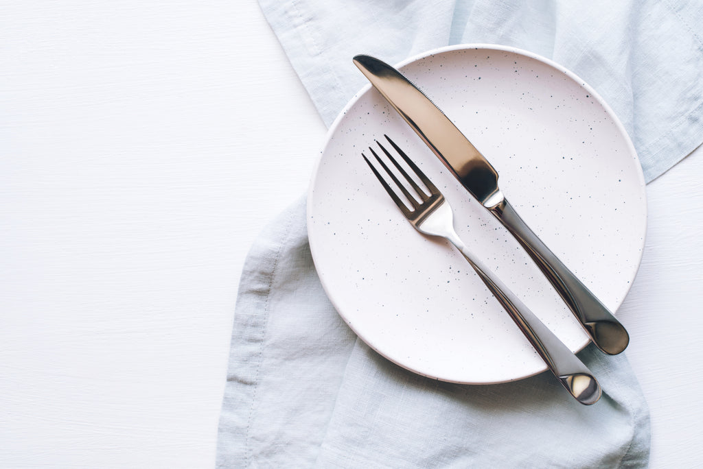 empty food plate with fork and knife