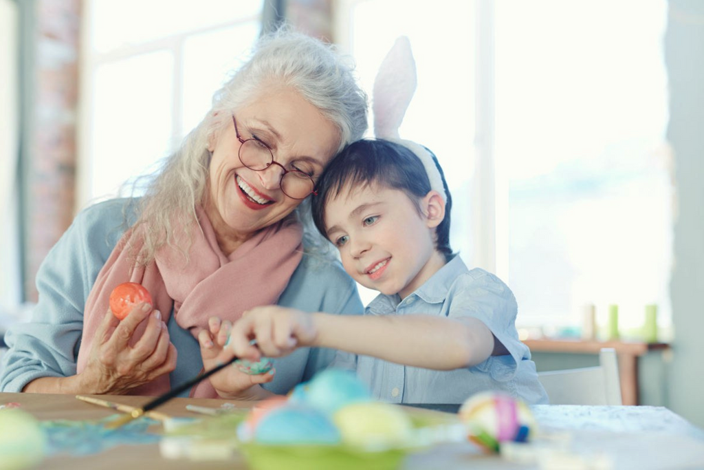 Grandmother and grandson painting Easter eggs together | Benefits Of Laughing To People's Health | medical benefits of laughing