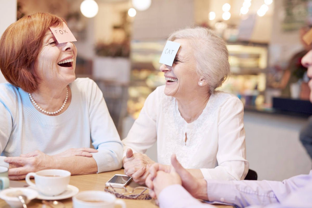 Seniors playing a humorous game | Benefits Of Laughing To People's Health | laughing benefits