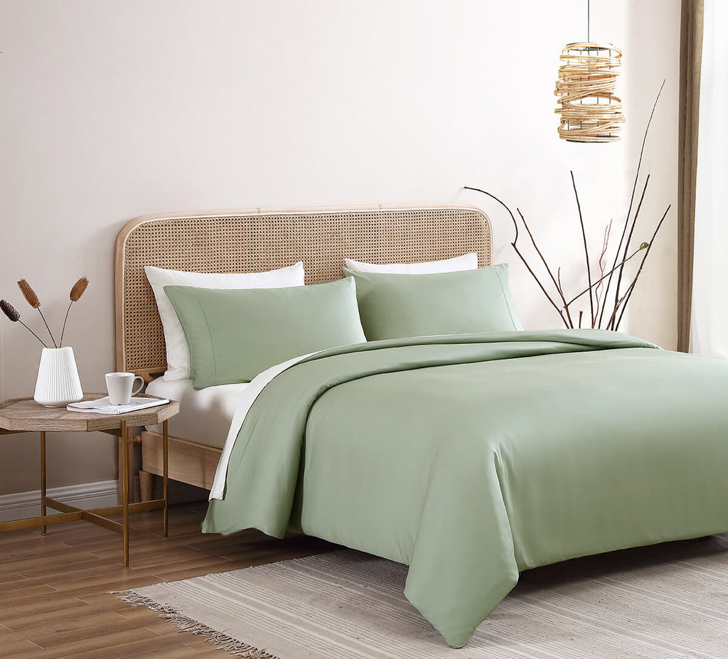 Sunday Citizen Premium Bamboo Duvet Cover in Sage and Premium Bamboo Sheet Set in Clear White. Green and white sheets.