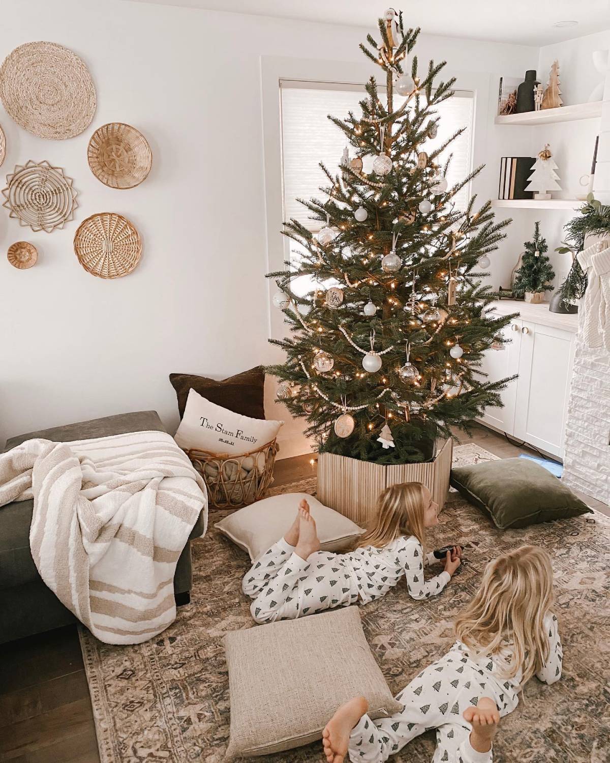 Christmas tree in living room. Christmas tree at home. Cozy by the Christmas tree. Laying on floor next to Christmas tree. Cozy pillows and blankets at Christmastime.
